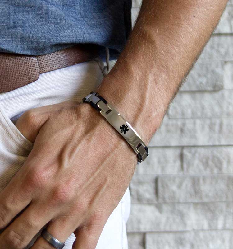 Man wearing stainless steel linked medical ID bracelet with silver and black accents