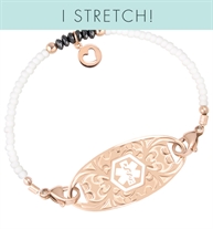 White seed beads and crystals with rose gold filled accents and a Rose gold circle charm with heart cutout