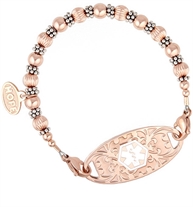 Interchangeable bracelet: Sterling silver and rose gold filled beads shown on white background attached to rose gold tone id tag