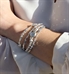 mulit strand bracelet made of Silver-leafed silver druzy quartz centerpiece and faceted, hammered, and matte sterling silver elements attached to stainless steel ID tag shown wrist